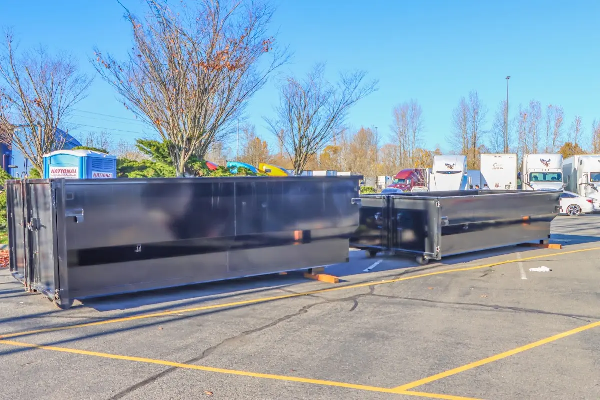 Professional dumpster rental service with roll-off container on residential driveway in Good Hope